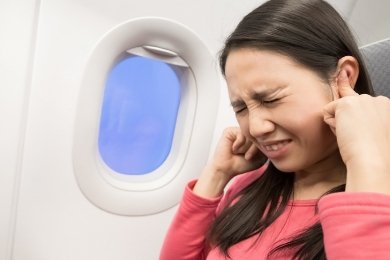 stock-photo-middle-aged-women-feel-tinnitus-in-the-airplane